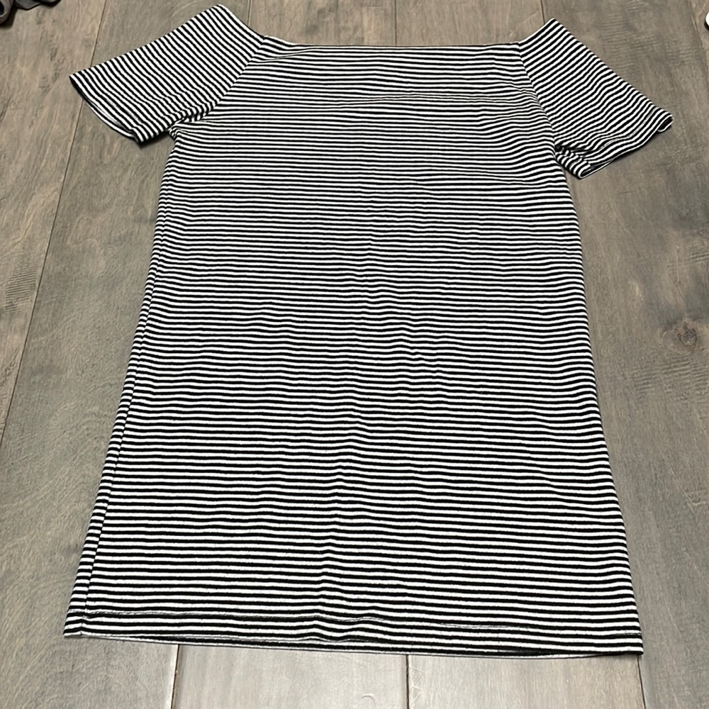 White and black striped, medium sized shirt for women.